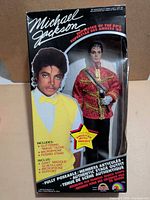 Front of boxed Michael Jackson doll showing figure and accessories