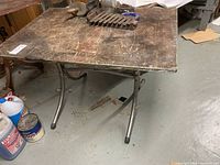 Top view of work table showing wood surface and items on top (contents excluded)