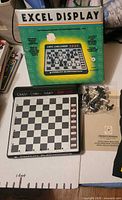 Full lot showing box, chess computer board, bag of pieces and manual