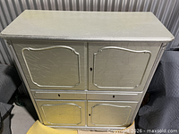 Front top view of silver-leaf cabinet showing crackle finish and panel details