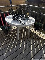 Overall lot showing table, lantern, solar lights, planters on deck