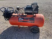 Full view of DeVilbiss ProAir II compressor with hose and regulator