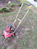 Full view of Homelite mini tiller showing frame, engine, wheels, tines