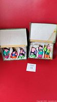Group shot showing both boxes open with eight figurines inside