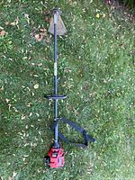 Full view of Toro gas string trimmer with shoulder harness