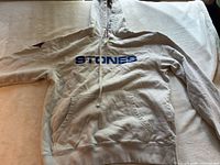 Full view of front of hoodie showing color, STONES text, pocket and hood