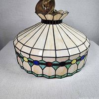 Full view of stained glass pendant shade showing overall form, chain and canopy