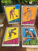 Group shot of all four basketball cards in sleeves