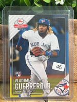 Front of the card inside a plastic sleeve showing player image and logos