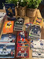 Spread of mixed Upper Deck hockey cards, various inserts and parallels in stacks; sealed Tim Hortons pack visible