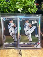 Front view of both Ricky Tiedemann Bowman Chrome Refractor cards in sleeves