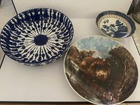 All three ceramic pieces: large splatter bowl, pastoral scene plate, small bird motif dish