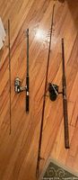 Overview of both rod and reel combos laid on floor