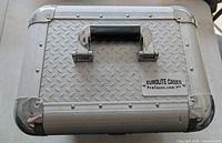 Top view showing handle, badge and diamond-plate texture