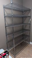 Full frontal view of chrome wire shelving unit with six shelves