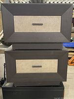 Front view of both nightstands showing drawer fronts and handles
