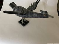 Left side view showing body texture, wing attachment, pedestal