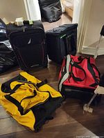 Group shot of all four luggage pieces standing/lying on floor