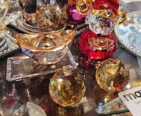 Group view showing red monkey figurine, amber gold ingot, two amber faceted spheres