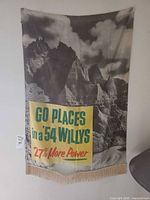 Full view of hanging Willys banner showing image, text and fringe