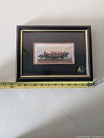 Front view of framed cavalry lithograph with crest, tape measure shows width