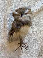 Front view of faux fur owl figurine showcasing coloration and facial details