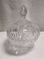 Full view of candy dish with lid on, showing overall shape and feet
