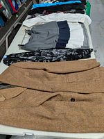 Table view showing brown blazer and folded skirts