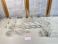 Full group of 22 etched floral glasses showing variety of styles and sizes