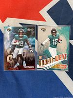 Both Travis Hunter rookie cards side by side in sleeves