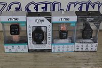 Group shot of four boxed iTime smartwatches showing band colours and prices