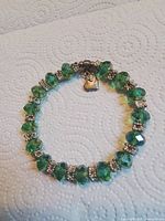 Full bracelet laid flat showing bead arrangement, spacers and charm