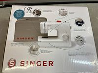 Front of retail box showing machine image and features