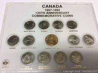 Full view of the sealed 125th Anniversary commemorative coin set for Canada from 1867 to 1992 showing all 13 coins in a plastic display case with each province or territory labeled.