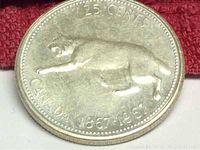 Obverse side of the 1967 Canada silver quarter showing a cougar and inscriptions including '25 CENTS' and 'CANADA 1867-1967'.