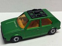 Front and side view of green die cast Matchbox Lesney VW Golf car showing orange interior and black roof rack