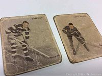 Two vintage hockey cards from the 1933-34 Ice Kings set, featuring Dan Cox and Cecil Dillon in black and white images with visible wear.