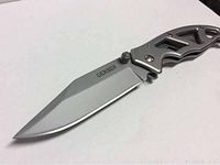 Close-up of Gerber folding knife blade showing brand marking and sharp edge.