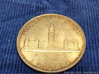 Another reverse side photo highlighting the coin's patina on blue background