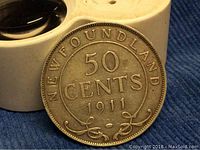 Close-up obverse side of the 1911 Newfoundland 50 cents silver coin showing the date and denomination clearly with some aging and patina visible on the surface.