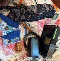 Group shot showing wooden box, necktie, Cool Tie packages, belt, valet case, phone holster