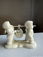 Front left view of figurine showing both Snowbabies and hanging pot