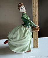 Side view showing full figurine and ruler for scale
