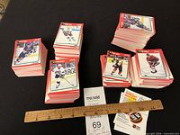 Stacks of 1991 Score hockey cards with ruler for scale and inserts visible