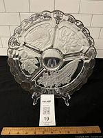 full view of round glass condiment dish on stand with measuring scale