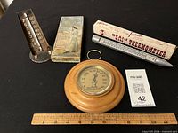 Group shot of all three thermometers, boxes, ruler for scale