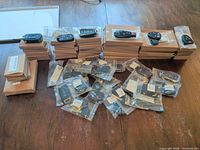 Stacked sealed cardboard boxes with individual key fobs displayed on top; bulk quantity shown