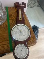 Close-up of barometer and hygrometer dials