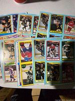 Assorted stacks of perforated hockey card panels spread on table