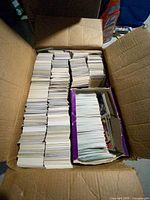 Box with multiple stacks of loose baseball cards